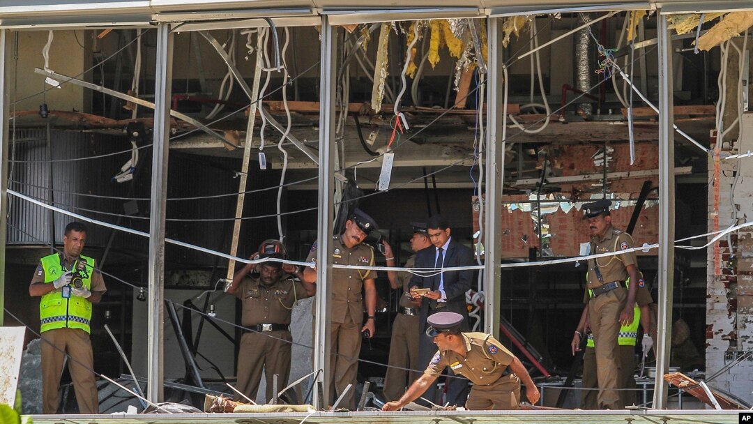 A Sri Lankan Police officer inspects a blast spot at the Shangri-la hotel in Colombo, Sri Lanka, Sunday, April 21, 2019. 