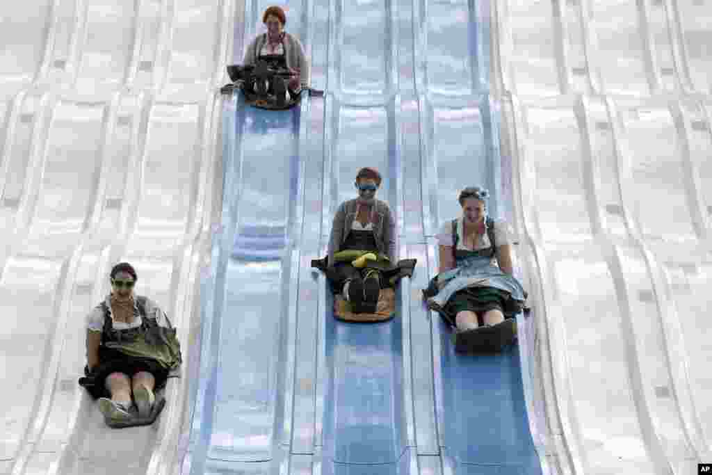 People enjoy a fun slide at the 183rd Oktoberfest beer festival in Munich, southern Germany.