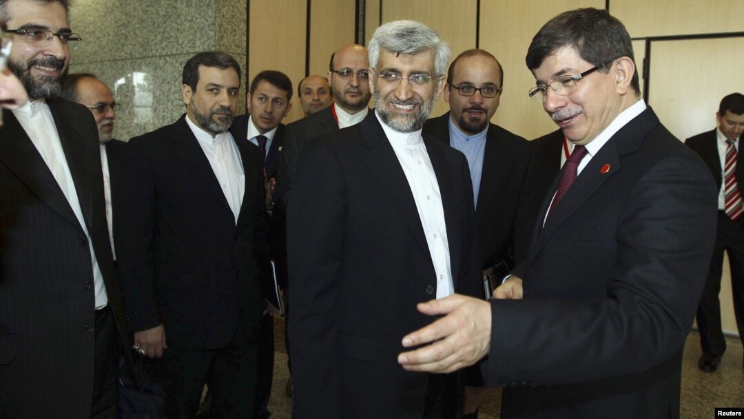 Turkey's Foreign Minister Ahmet Davutoglu [R] welcomes Iran's chief negotiator Saeed Jalili [2nd R] before their meeting in Istanbul, April 14, 2012.