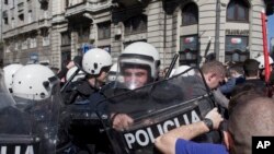 Riot police clash with protesters in Belgrade, Serbia, Sunday, March 17, 2019. 