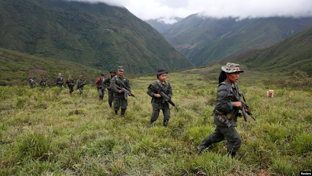 FILE - Members of the 51st Front of the Revolutionary Armed Forces of Colombia (FARC) patrol in the remote mountains of Colombia, Aug. 16, 2016. 