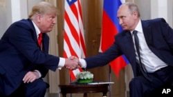 FILE - U.S. President Donald Trump, left, and Russian President Vladimir Putin, right, shake hands at the beginning of their meeting at the Presidential Palace in Helsinki, Finland, July 16, 2018. 