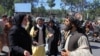 An Afghan woman protester speaks with a member of the Taliban during a protest in Herat on Sept. 2, 2021.