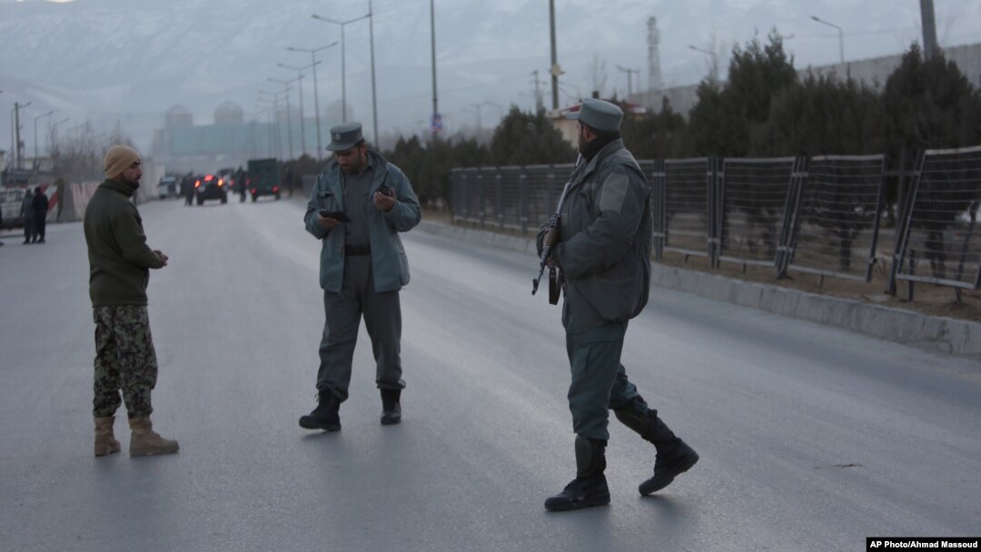Afghan security forces stand guard near the site of two blasts in Kabul, Afghanistan, Jan. 10, 2017. 