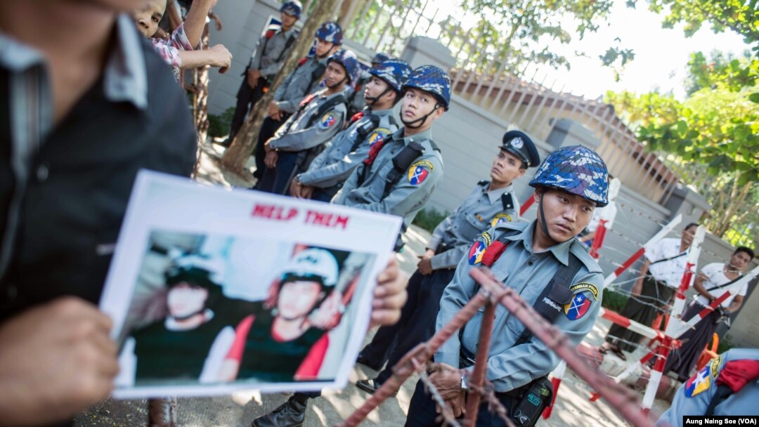 Police block protestors outside the Thai embassy in Yangon.