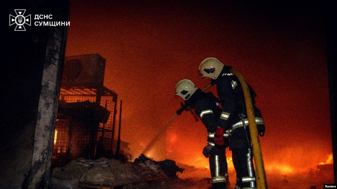FILE - Firefighters work at the site of a warehouse hit by a Russian drone strike, amid Russia's attack on Ukraine, in Sumy, Ukraine, March 6, 2025. (Press service of the State Emergency Service of Ukraine in Sumy region/Handout via Reuters)