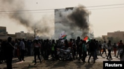 Protesters march during a rally against military rule following coup in Khartoum, Sudan, Feb. 10, 2022.