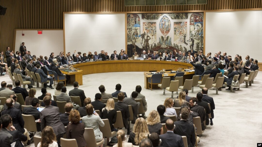 In this photo provided by the United Nations, the United Nations Security Council votes on a resolution that threatens Syria with new sanctions in New York, July 19, 2012.