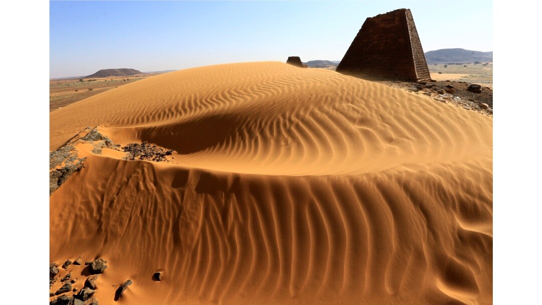 Creeping desert sands surround the Royal Cemeteries of Meroe Pyramids in Begrawiya at River Nile State, Sudan, Nov. 10, 2019.