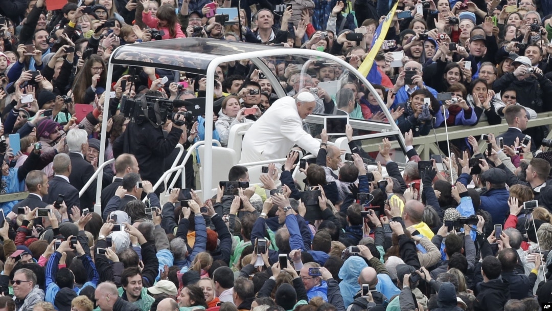 FILE - Pope Francis salutes faithful gathered in St. Peter's Square at the Vatican, April 5, 2015. 