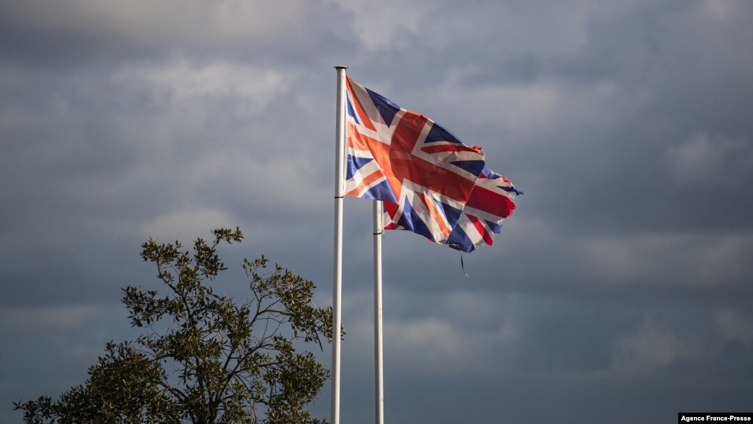 This photograph taken on Dec. 10, 2021, shows the Britain flags wave, in the harbor of Ouistreham, northwestern France. 