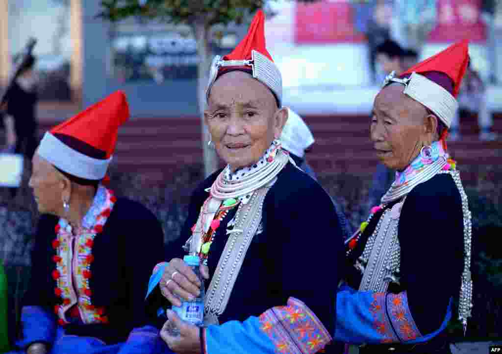 Women dressed as ethnic minorities on a business street in Beijing. The seven-day holiday built around China's National Day on October 1 sees millions of members of China's newly wealthy and mobile middle-class travel locally and abroad.