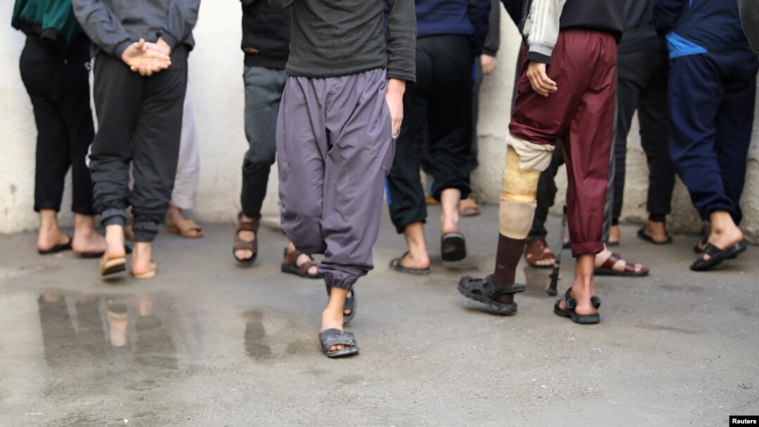 FILE - Prisoners from Iraq and Syria, suspected of being Islamic State fighters or supporters, are seen inside a prison in Hasaka, Syria, Jan. 11, 2020.