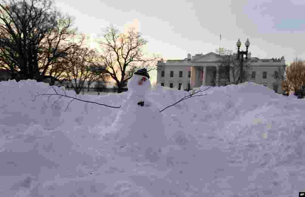 "A snowman" stands in Lafayette Park, across the street from the White House in Washington, Monday, Jan. 25, 2016. East Coast residents face fresh challenges as the workweek begins: slippery roads, spotty transit service mounds of snow, and closed schools and government offices. (AP Photo/Carolyn Kaster)
