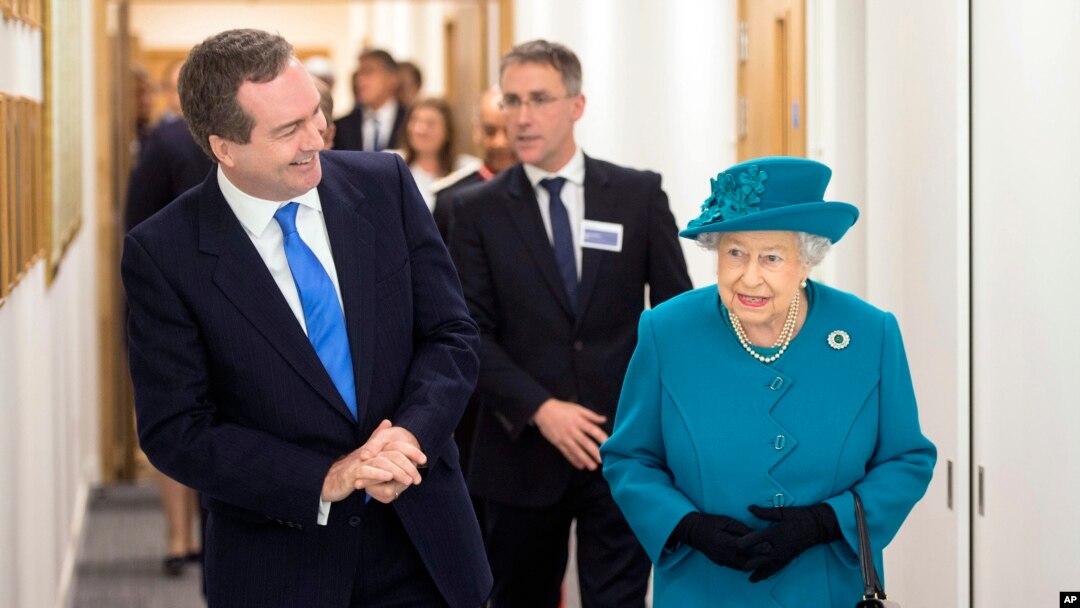 Britain's Queen Elizabeth II, right, walks with Director of GCHQ (Government Communications Headquarters) Robert Hannigan, during a visit to officially open the National Cyber Security Center (NCSC) in London, Feb. 14, 2017.