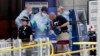 Forensic officers investigate the scene near the Manchester Arena, Manchester, England, May 23, 2017, the day after the suicide attack at an Ariana Grande concert that left 22 people dead as it ended on Monday night.