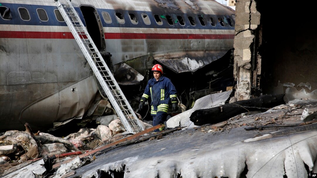This photo provided by Mizan News Agency, shows an Iranian rescue works at the site of a Boeing 707 cargo plane crash, at Fath Airport about 40 kilometers (25 miles) west of Tehran, Iran, Jan. 14, 2019.