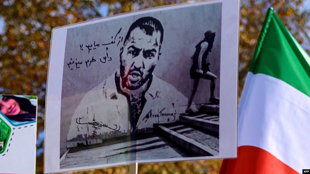 FILE - People hold placards bearing portraits of Iranian rapper Toomaj Salehi, who is arrested in Iran during a rally in support of Iranian women in Istanbul, on November 26, 2024.