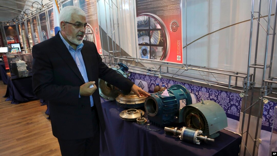 Deputy head of the Atomic Energy Organization of Iran Asghar Zarean explains about a part of a machine of the country's nuclear facilities in Tehran, Iran, Sept. 1, 2014. 