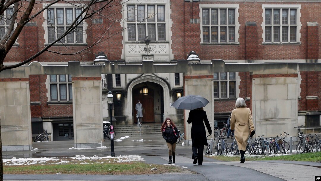 FILE - People walk near the campus center at Princeton University in Princeton, N.J., Dec. 9, 2013. 
