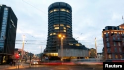 FILE - Traffic flows in front of the Bank for International Settlements (BIS) in Basel, Switzerland.