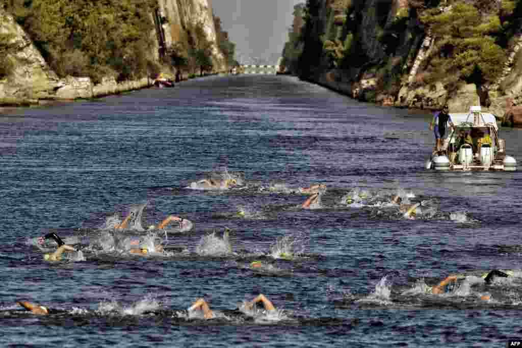 Participants of a 'swim accross the canal ' race move through the 6,346-meter-long Corinth canal, near the city of Corinth, Greece.
