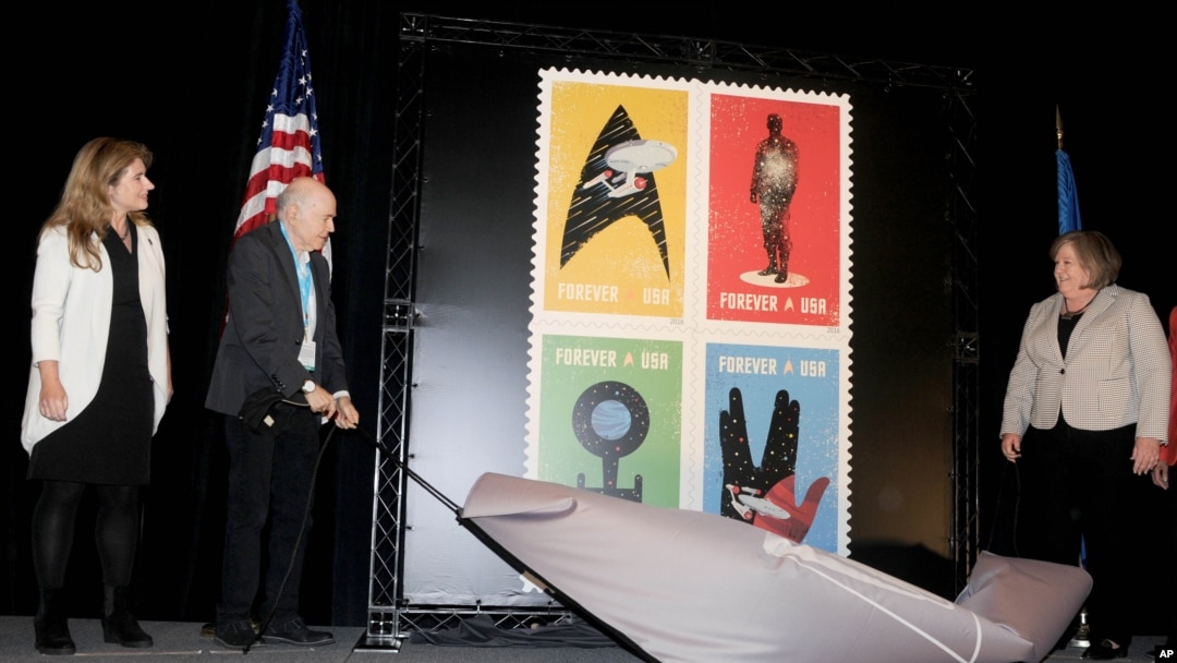El actor y humanitario Walter Koening, la jefe del Servicio Postal de EE.UU. Meagan Brennan y la vicedirectora de Ciencias de la NASA para Comunicaciones Michelle Thales presentan las estampillas en honor del 50 aniversario de Star Trek.