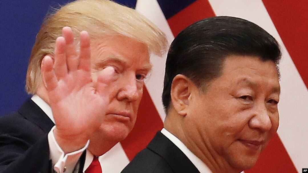 FILE - Chinese President Xi Jinping walks with U.S. President Donald Trump, Nov. 9, 2018, after attending a business event at the Great Hall of the People in Beijing. 