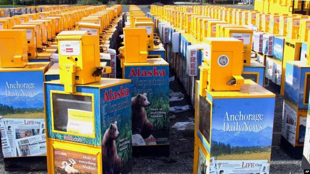 FILE - Hundreds of old newspaper sales boxes sit in a vacant lot near the former offices of the Alaska Dispatch News in Anchorage, Alaska, Sept. 11, 2017.