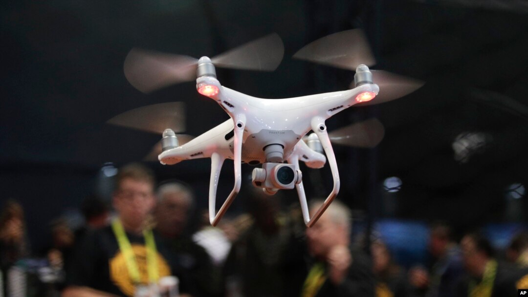 FILE - In this Jan. 5, 2017 file photo, an exhibitor demonstrates a drone flight at CES International, in Las Vegas. President Donald Trump signed a memorandum permitting states, localities and tribes to craft their own pilot programs to test drones, Oct. 25, 2017.