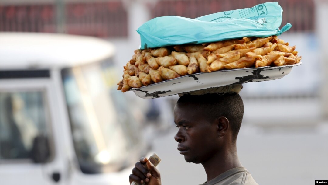 FILE - A man sells samosas at a marketplace in Burundi's capital Bujumbura.