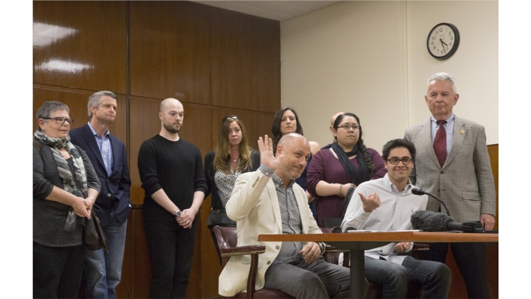 FILE - A juror raises his hand while speaking to the press at the state Supreme Court after the judge declared a mistrial in the case of slain missing child Etan Patz, New York, May 8, 2015.
