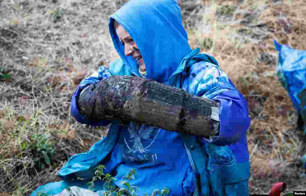 An environmental activist with her hands locked in a pipe filled with concrete and several other activists block the transport rail to a nearby brown coal power plant to protest against the clearance of the forest "Hambacher Wald", near Elsdorf, Germany.
