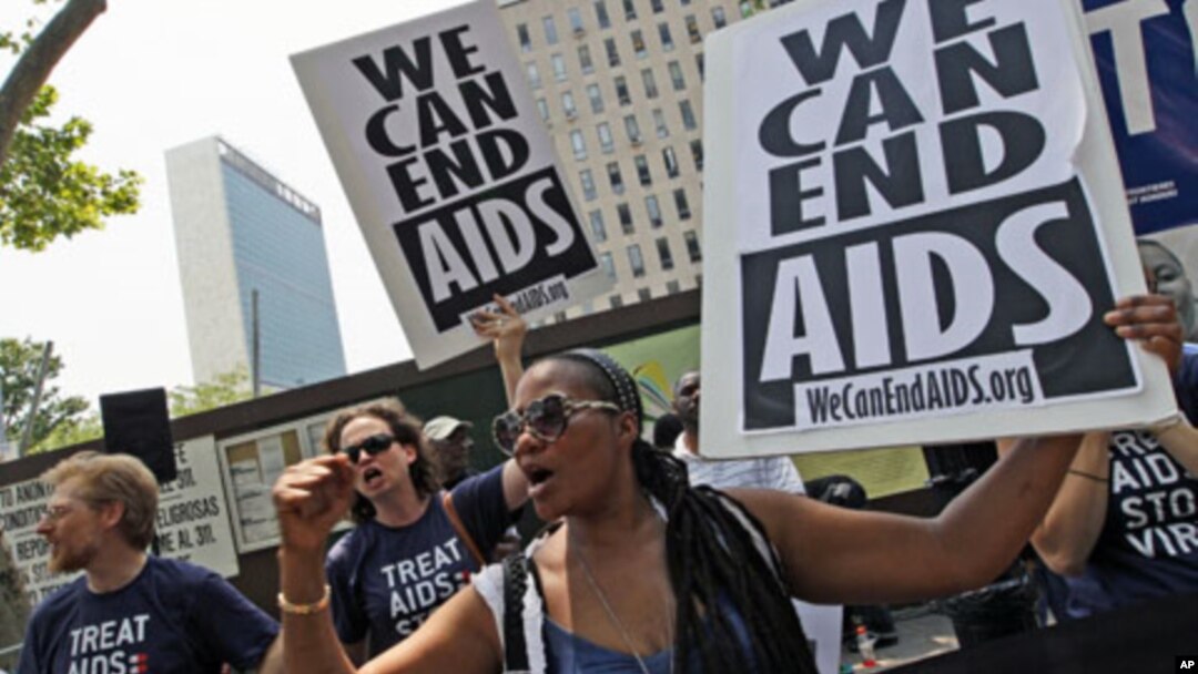 Cassandra James, right, Emily Bass, and Mitchell Warren chant slogans during a demonstration in New York. AIDS activists from around the world rally outside the United Nations headquarters calling for full funding for global AIDS treatment and prevention,