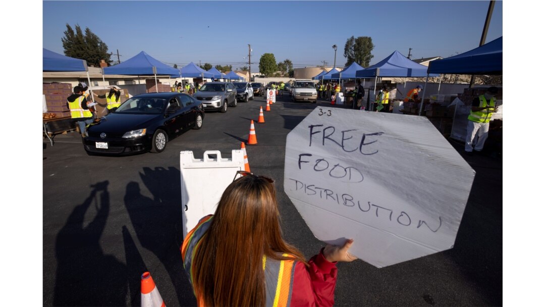 Cars line-up as the Los Angeles Regional Food Bank distributes food outside a church during the outbreak of COVID-19 in Los Angeles, California, Nov. 19, 2020.