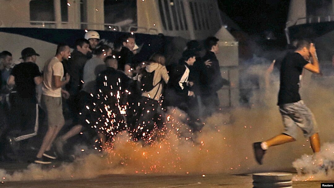 Police disperse revellers at the old port of Marseille after the England v. Russia - Group B match. 