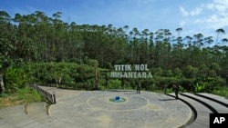 FILE - Indonesian soldiers take photos at the 'ground zero', the center of the site of the new capital city 'Nusantara', in Penajam Paser Utara, East Kalimantan, Indonesia, on March 8, 2023. 