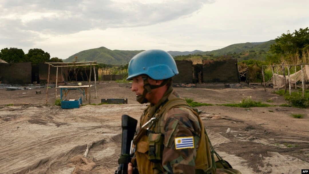 FILE - A UN soldier patrols the area surrounding the village of Kafe, at Lake Albert in Ituri, March 27, 2018. Conflict between members of the Lendu and Hema tribes has caused the instability within the Ituri region and thousands of Hema people to flee.