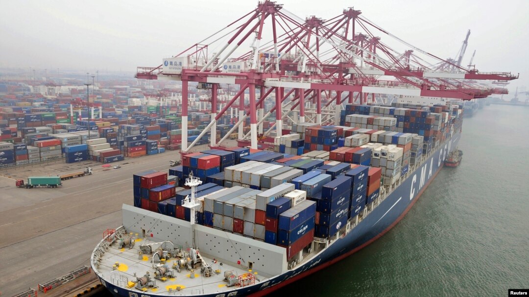 A cargo ship loaded with containers is seen anchored at a port in Qingdao, Shandong province, China, July 10, 2013.