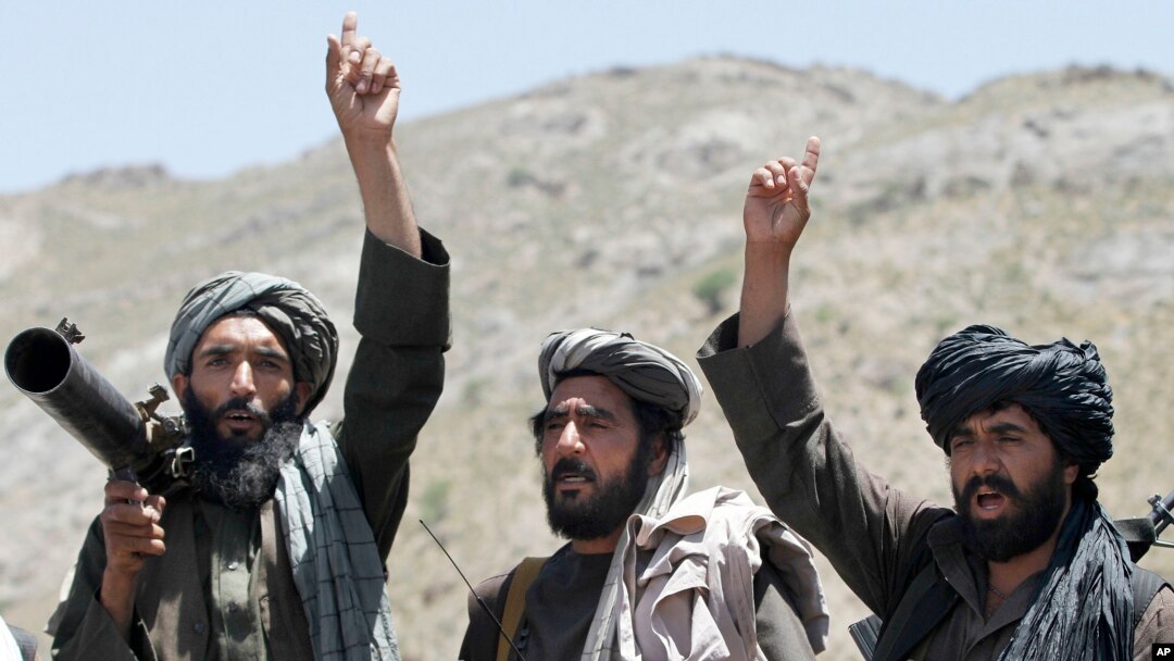 FILE - Taliban fighters react to a speech by their senior leader in the Shindand district of Herat province, Afghanistan. 