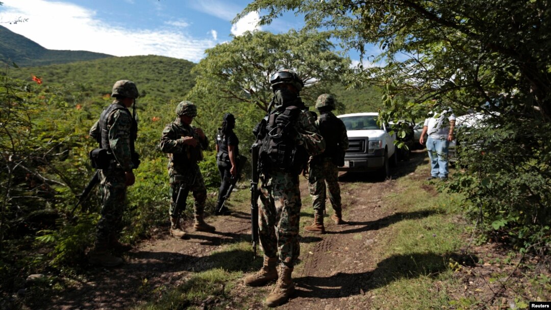 Soldiers guard an area where a mass grave was found, in Colonia las Parotas on the outskirts of Iguala, in Guerrero, Mexico, Oct. 4, 2014.
