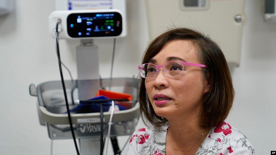 Clinical nurse Tram Pham becomes teary eyed remembering how hard it was at first, adjusting to life in the U.S. as a refugee from Vietnam at the Valley Health Center TB/Refugee Program in San Jose, California, on Dec. 9, 2021.