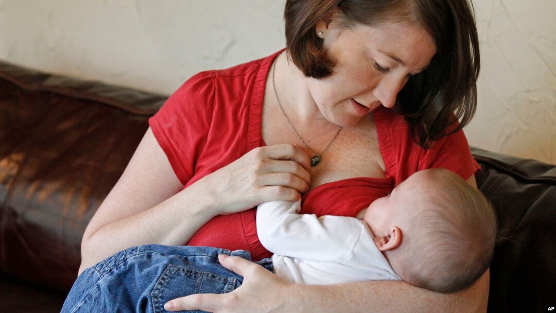 FILE - Jessica Ewald breast-feeds her 5-month-old son, Bennett, at her home in Oakbrook Terrace, Ill., Sept. 14, 2011.