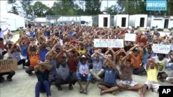 In this file photo made from Australia Broadcasting Corporation video made Oct. 31, 2017, asylum seekers protesting the possible closure of their detention center, on Manus Island, Papua New Guinea. 