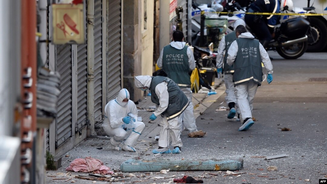 French forensics police search for evidence outside a building in Saint-Denis, where special forces raided an appartment, hunting those behind the attacks that claimed 129 lives in Paris last week, Nov. 18, 2015.