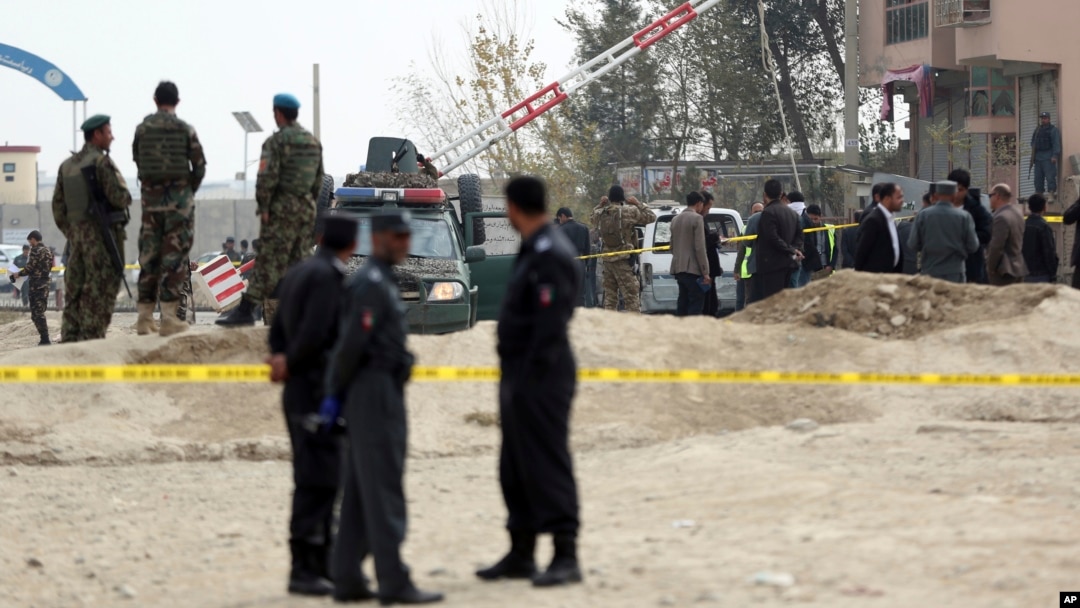 Security forces inspect the site of a suicide attack on prison employees' vehicle in Kabul, Afghanistan, Oct. 31, 2018. 